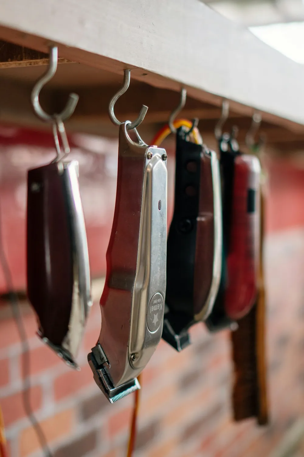 Straight razors hanging along the wall